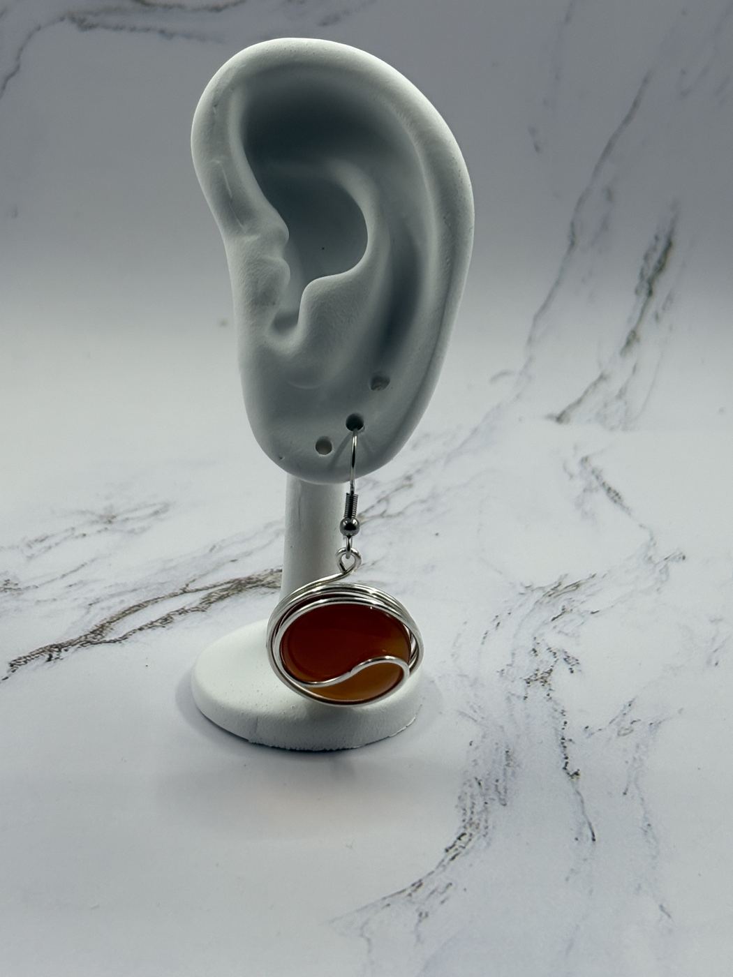Infinity stone dangle earring with a red stone