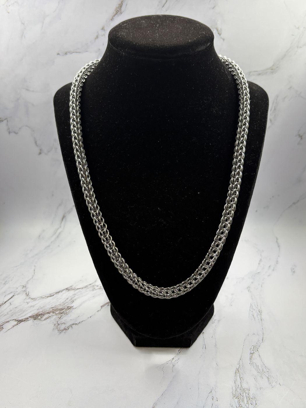 Urban Maille chainmaille necklace on a black display bust
